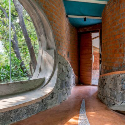 Curved brick hallway with natural light - Farmhouse in Alibag - Sustainable, eco friendly, biophilic architects in Mumbai, India