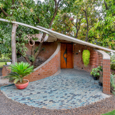 Modern eco home entrance with lush greenery - Farmhouse in Alibag - Sustainable, eco friendly, biophilic architects in Mumbai, India