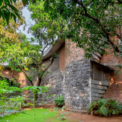 Brick and stone building surrounded by greenery - Sustainable, eco friendly, biophilic architects in Mumbai, India