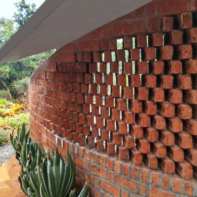 Red brick wall with sustainable architecture design - Sustainable, eco friendly, biophilic architects in Mumbai, India