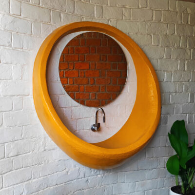 Unique circular mirror with rustic brick backdrop - Farmhouse in Alibag - Sustainable, eco friendly, biophilic architects in Mumbai, India