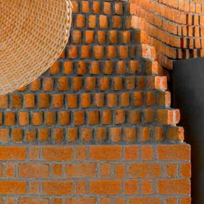 Corbel brick wall with natural texture - Farmhouse in Alibag - Sustainable, eco friendly, biophilic architects in Mumbai, India