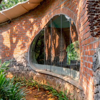 Curved brick and stone architecture with greenery - Farmhouse in Alibag - Farmhouse in Alibag - Sustainable, eco friendly, biophilic architects in Mumbai, India