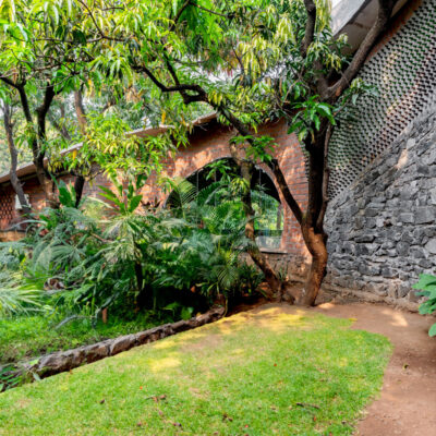 Lush garden pathway beside eco-friendly architecture - Farmhouse in Alibag - Sustainable, eco-friendly, biophilic architects in Mumbai, India.
